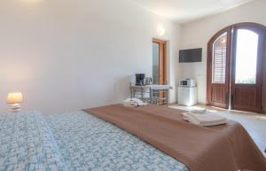 a bedroom with a bed with two towels on it at Dammuso Ignazio in Lampedusa