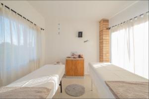 a bedroom with two beds and a window at La Cautiva in Los Reartes +25 photos