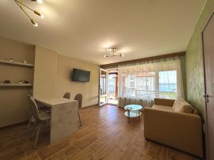 a living room with a couch and a table at Seagull Apartments in Byala