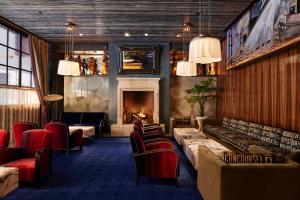 a room with a fireplace and chairs and a fire place at The Maritime Hotel in New York