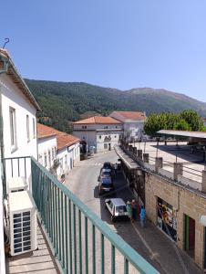 a view of a street with cars parked in a town at Casa Serradalto in Manteigas