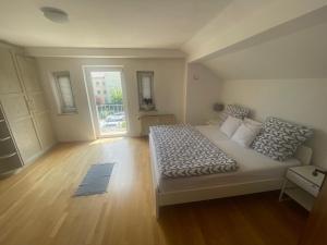 a bedroom with a large bed and a window at Ruhige Ferienwohnung in Rosenheim in Rosenheim