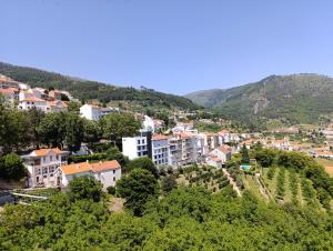a town on a hill with houses and trees at Casa Serradalto in Manteigas