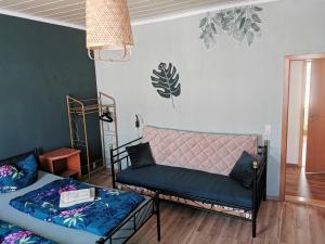 a living room with two beds and a couch at SaxonyBNB in Waldheim