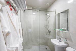 a bathroom with a shower and a sink at Golden Horizon Hotel in Tashkent +24 photos