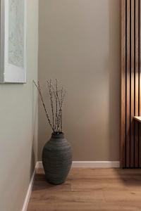 a vase sitting on the floor in a room at Frederiksdal Sinatur Hotel & Konference in Kongens Lyngby