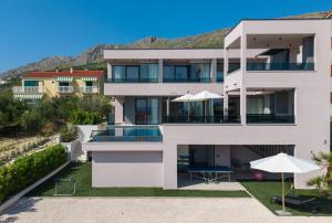 an image of a house with a swimming pool at NEW! Villa Pavuza – Luxury 4-Bedroom Seaview Villa in Podstrana