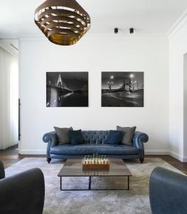 a living room with a blue couch and a coffee table at Maison 45 - Luxury Boutique Hotel in Budapest