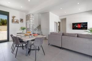 a living room with a table and a couch at Villa Meraki in Stalos