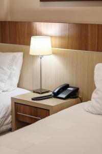 Rúm í herbergi á Bella Vista Hotel - Encarnación
