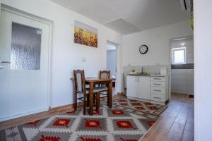 a kitchen and dining room with a table and chairs at Ilidža Garden Escape in Sarajevo