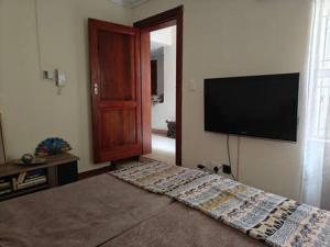 a living room with a flat screen tv on the wall at 7 on school - Cozy guesthouse 15 min drive from airport and close to major highways in Germiston