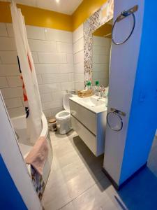 a bathroom with a white toilet and a sink at Maison de Village in Canet d'Aude +17 photos