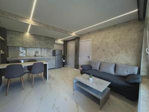 a living room with a couch and a table at Seagull Apartments in Byala