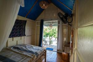 a bedroom with a bed with a blue ceiling at Vietnam Surf Camp in Ấp Mỹ Hải