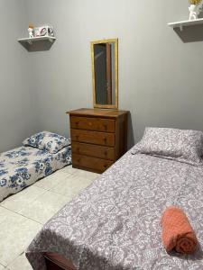 a bedroom with two beds and a dresser and a mirror at Apto no centro de Belém Nos altos in Belém