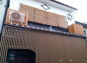 Un edificio con un reloj en el costado. en Kyoto Villa Kotone, en Kioto