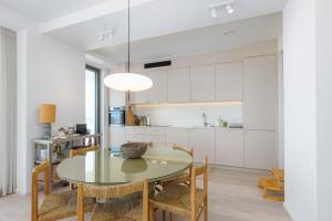 a dining room with a glass table and chairs at Central Heaven in Ostend