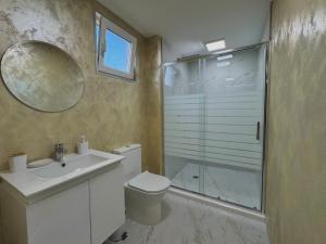 a bathroom with a shower and a toilet and a sink at Seagull Apartments in Byala +14 photos