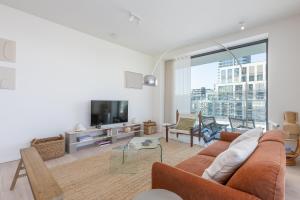 a living room with a couch and a tv at Central Heaven in Ostend