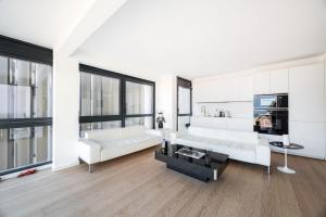 a living room with white furniture and large windows at Luxury 3BR Apartment with Sea View in Beausoleil