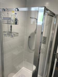 a bathroom with a shower with a glass door at Featured on Channel 4 with George Clarke with lazy spa in Bournemouth +78 photos