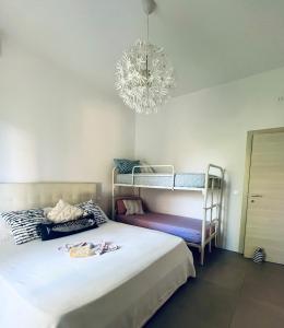 a bedroom with a bed with a chandelier and bunk beds at Zadina Family Home in Cesenatico