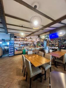 a restaurant with tables and chairs and a store at Locanda Baita dei Forti in Malcesine