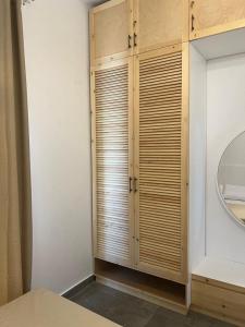 a bathroom with a wooden closet with a mirror at Caesar Sodic in Ras Elhekma