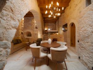 a dining room with a table and chairs at Santa Veneranda Suites "by Checkin" in Ayía Paraskeví