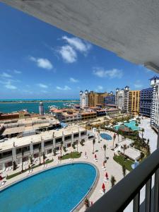 a view from the balcony of a resort with a pool at Porto Marina North Cost, Coastal Panorama in El Alamein +34 photos