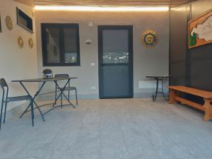 a room with a blue door and a table and a bench at DOMUS ULIVI LUXURY ROOMS Nocellara in Catania