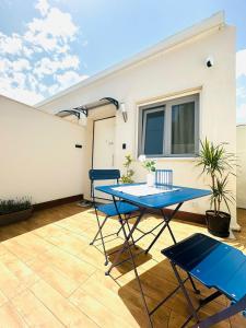 a patio with a blue table and two chairs at La MAISON D'ISABELLE in Bari +17 photos
