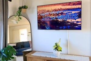 a living room with a painting on the wall at Jayla's By The Marina 2bdr in Batemans Bay