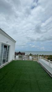 a large balcony with a view of the ocean at Astara Villa Kiraye in Astara