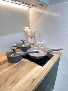 two pans sitting on top of a kitchen counter at Bamboo 754 in Ts'ikhisdziri +31 photos