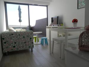 a living room with a table and a chair at Sesimbra Bay Apartment in Sesimbra