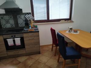 a kitchen with a table and a stove and a table and chairs at Apartma Lara in Bled +30 photos