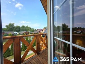 a view from the balcony of a house at 365PAM - Urocze Domki Letniskowe blisko morza in Bobolin