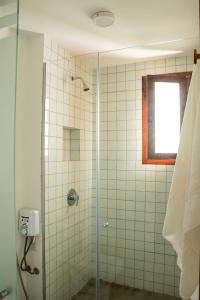 eine Dusche mit Glastür im Badezimmer in der Unterkunft Casa Cajú in Cruz + 30 Fotos