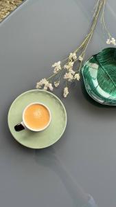 a cup of coffee on a plate next to a purse at Grayscale Studio in Caniço