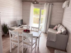 a living room with a table and a couch at Casa Silva in Zambujeira do Mar