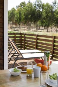 a table with plates of food and oranges and juice at Casa Silva in Zambujeira do Mar