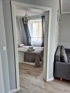 a small bedroom with a bed and a window at Apart 36 in Lębork