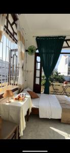a bedroom with two beds and a table with food on it at Hotel Ngọc My in Phan Thiet