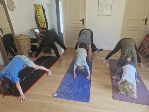 a group of people doing yoga on mats on the floor at Ananda in Le Mans