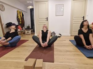 a group of women sitting on the floor in a yoga pose at Ananda in Le Mans