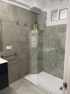 a shower with a glass door in a bathroom at Alquiler en el puerto de los cristianos in Arona +5 photos