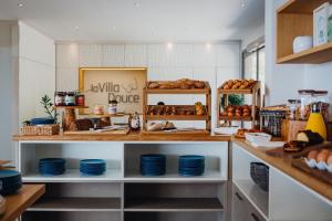 a bakery with blue plates and pastries on shelves at Hôtel La Villa Douce in Rayol-Canadel-sur-Mer