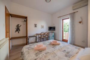 a bedroom with a table with two pink pillows on it at Casa Botin in Rovinj